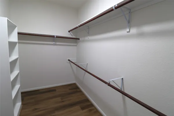 a view of a room with wooden floor