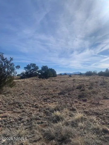 a view of a large building with a field