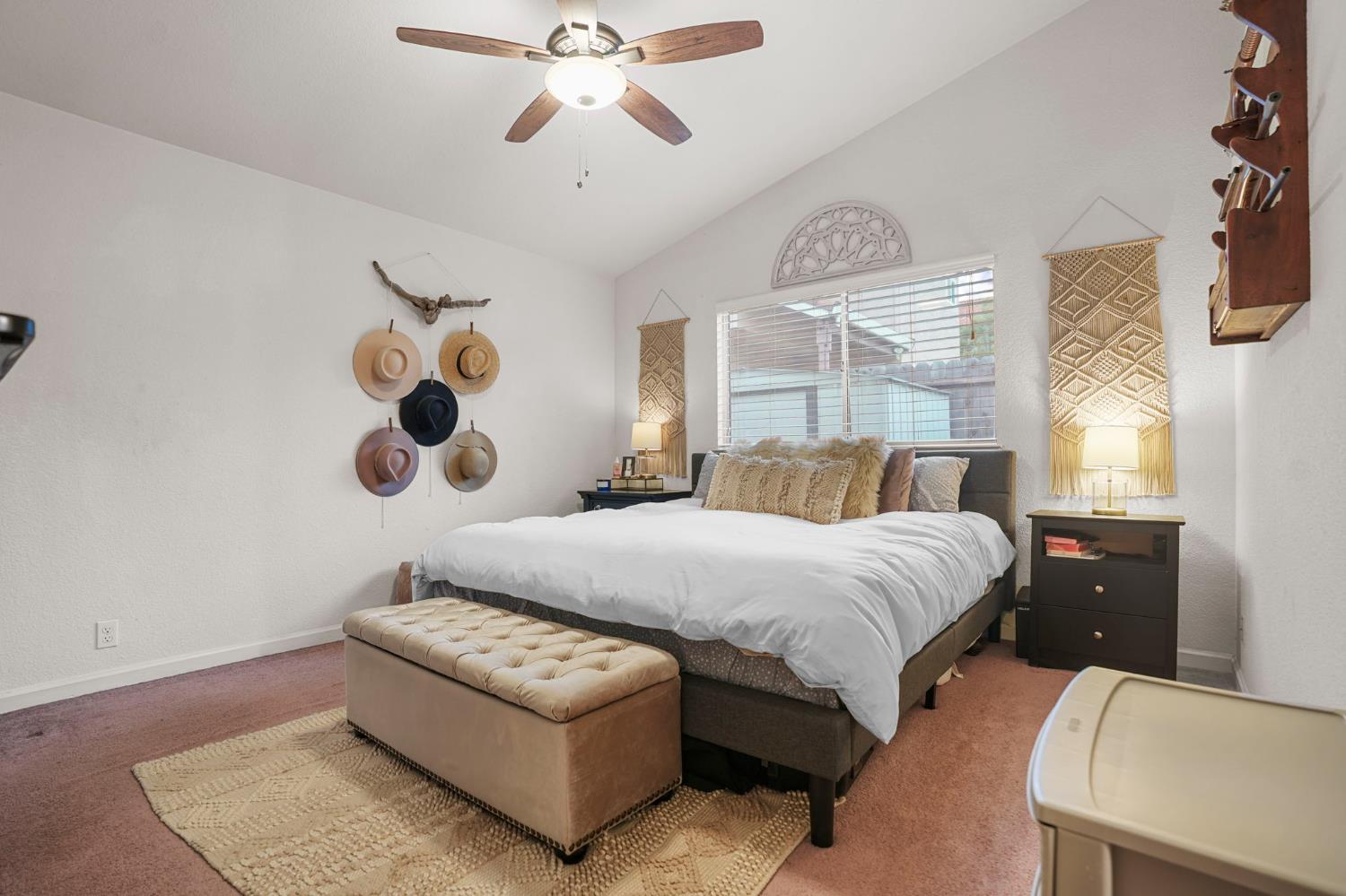 1017 Jayhawk Way Modesto, CA 95358 - Photo 12 of 32 a bedroom with a large bed and a chandelier