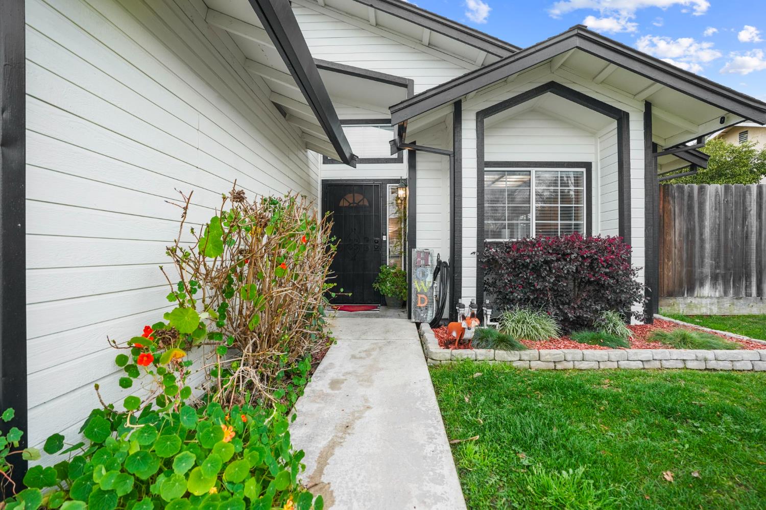 1017 Jayhawk Way Modesto, CA 95358 - Photo 4 of 32 a front view of a house having a yard