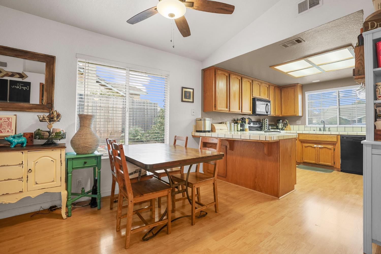 1017 Jayhawk Way Modesto, CA 95358 - Photo 8 of 32 a kitchen with a stove a sink a dining table and chairs