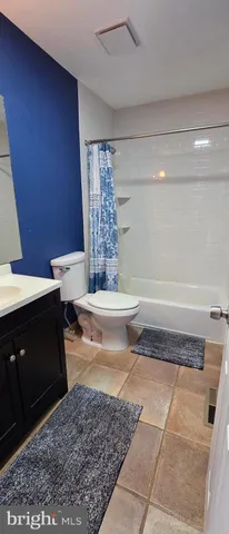 a bathroom with a granite countertop bathtub and sink