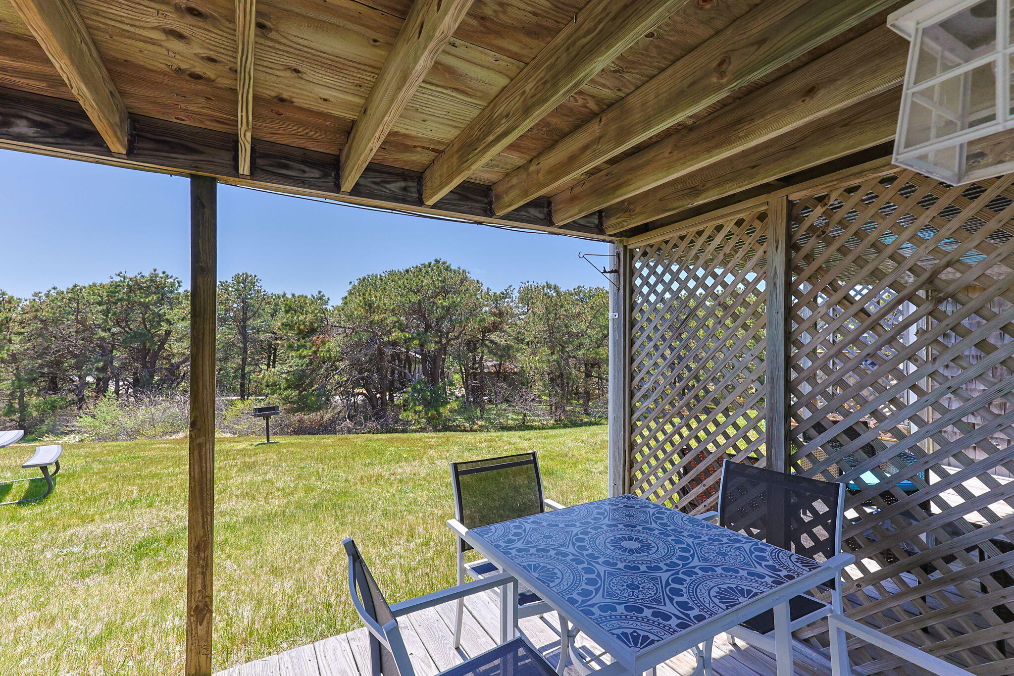 132 Shore Road, Unit 13 Truro, MA 02666 - Photo 15 of 21 a view of a patio with a table chairs and garden view