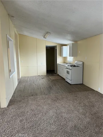 a kitchen with a stove a sink and a window