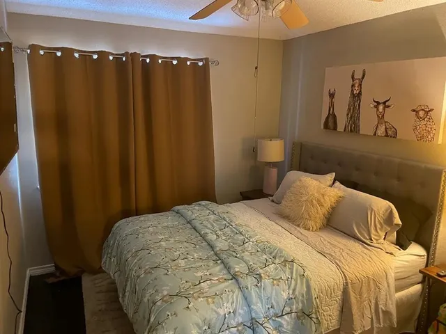a bedroom with a bed and a mirror