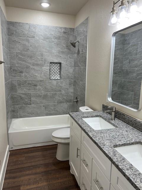 3003 Steepleridge Circle Granbury, TX 76048 - Photo 2 of 8 a bathroom with a granite countertop toilet a sink and bathtub