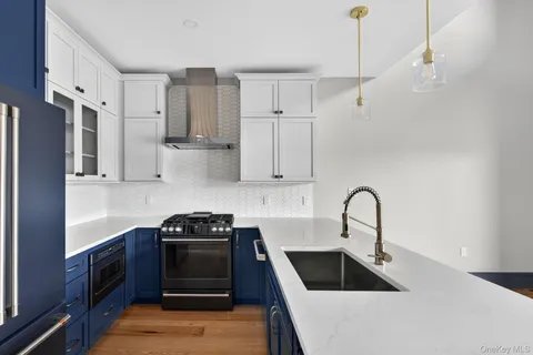 a kitchen with sink a stove and refrigerator