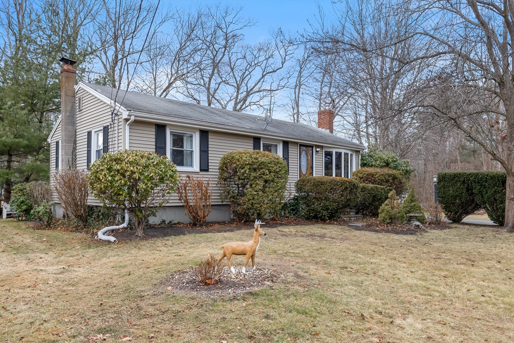 a view of a house with backyard and sitting area