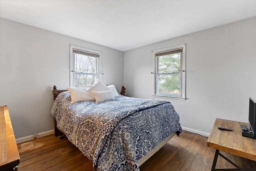 90 Washington Terrace Whitman, MA 02382 - Photo 12 of 18 a bedroom with a bed and wooden floor