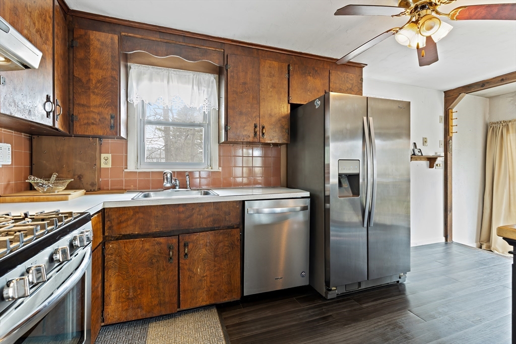 90 Washington Terrace Whitman, MA 02382 - Photo 2 of 18 a kitchen with stainless steel appliances granite countertop a refrigerator a sink and a stove