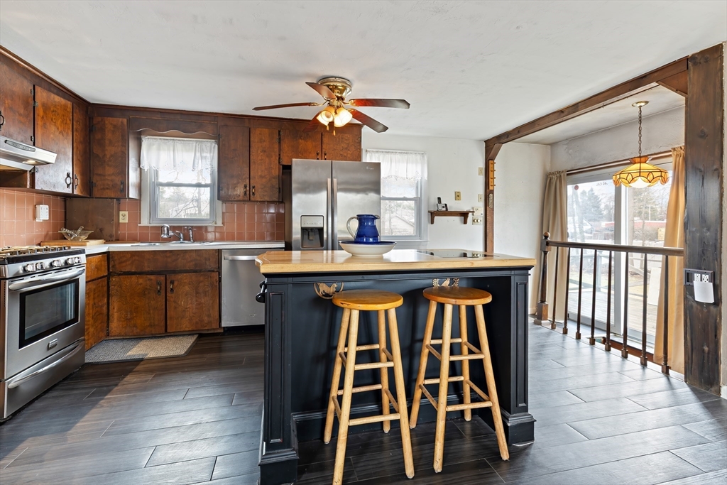 90 Washington Terrace Whitman, MA 02382 - Photo 3 of 18 a kitchen with a sink stove and cabinets