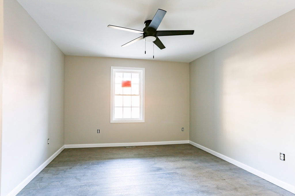 95 Town Farm Road Warren, MA 01083 - Photo 23 of 38 an empty room with a window and a ceiling fan