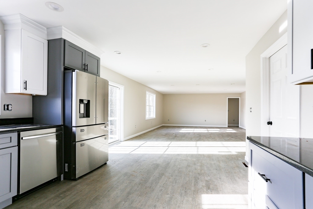 95 Town Farm Road Warren, MA 01083 - Photo 8 of 38 a kitchen with granite countertop a refrigerator and a stove top oven