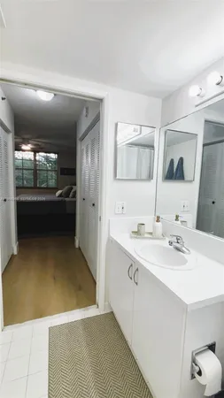 a bathroom with double vanity and a mirror