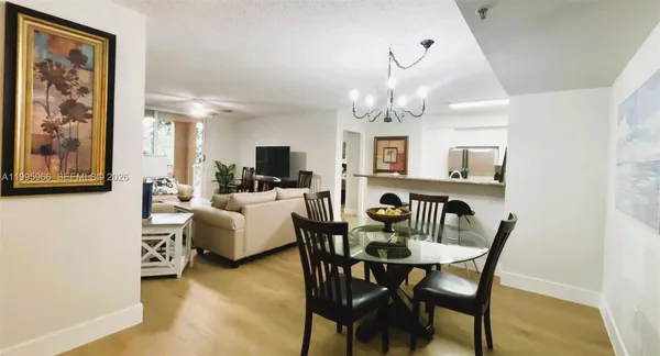 a living room with furniture a large window and a flat screen tv