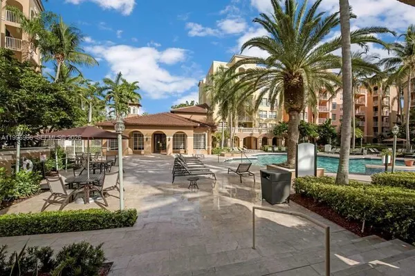 a view of kitchen with furniture and refrigerator