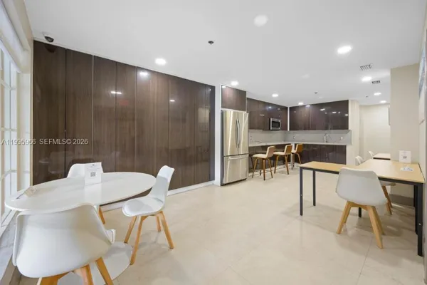 a backyard of a house with wooden floor and outdoor seating