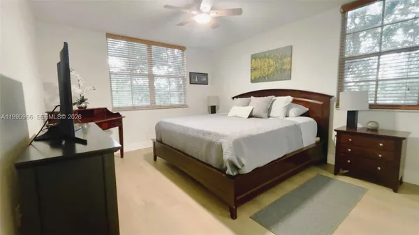 a bathroom with a sink a large mirror and a shower