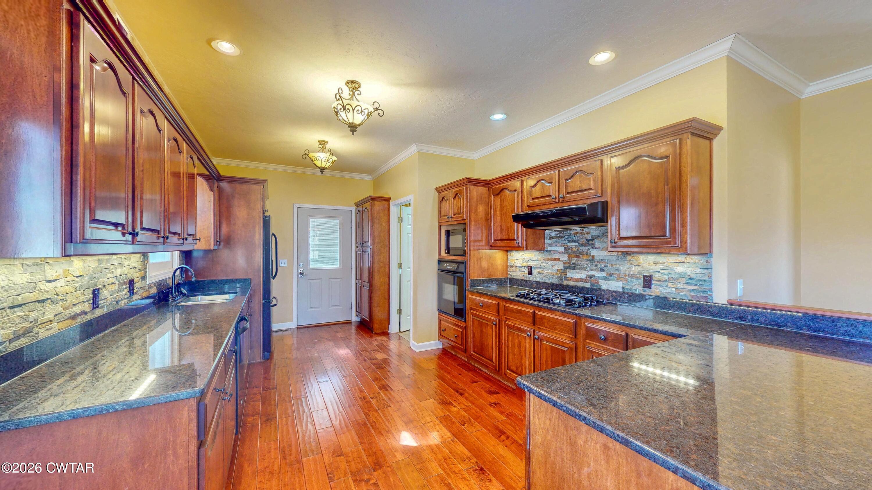 101 Oak Lane Gleason, TN 38229 - Photo 15 of 50 a kitchen with stainless steel appliances granite countertop sink stove refrigerator and cabinets