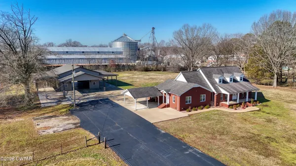 a view of a house with a yard and sitting area