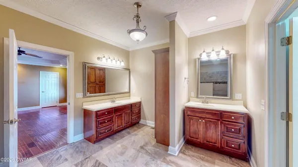 a bathroom with a sink a vanity and a large mirror