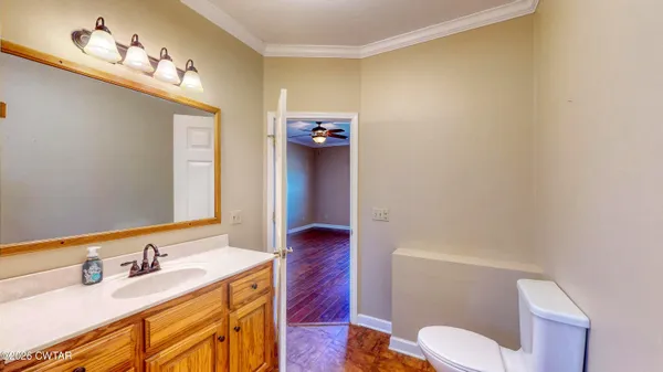 a bathroom with a sink vanity mirror and toilet