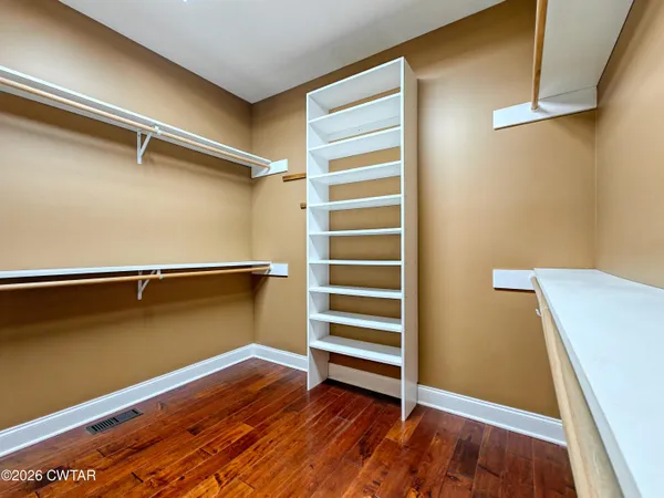 a view of room with wooden floor and window