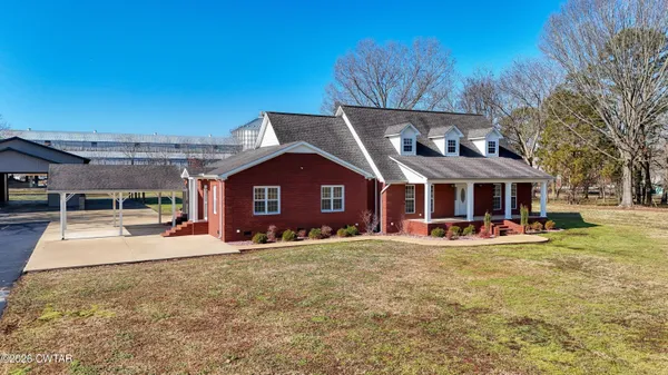 a view of a house with a yard patio and fire pit
