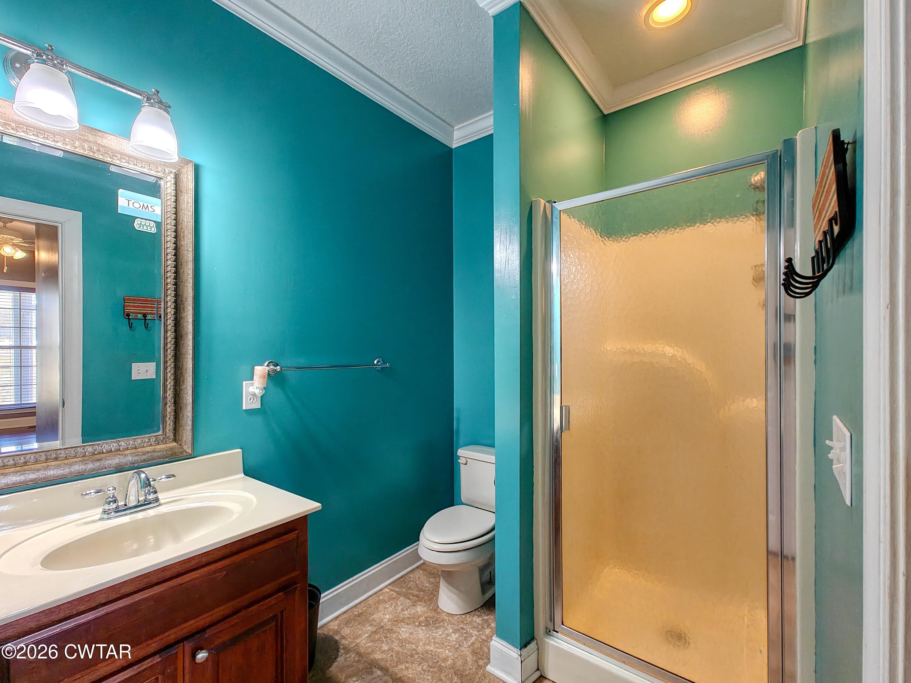 101 Oak Lane Gleason, TN 38229 - Photo 31 of 50 a bathroom with a granite countertop sink toilet and shower