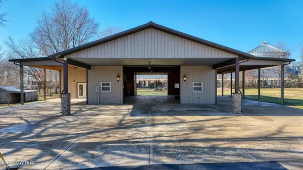 a view of a house with entrance door and a yard
