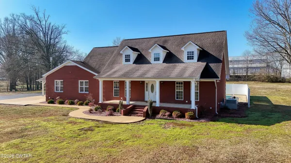 a view of a house with swimming pool in front of it