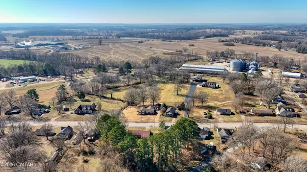 a view of a house with a yard and garage