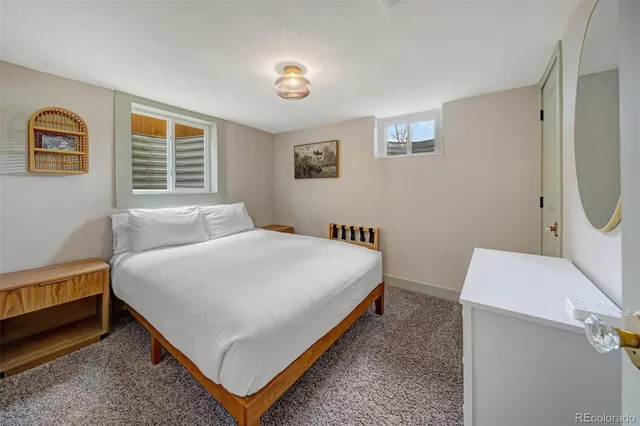 a bedroom with a bed and a chair