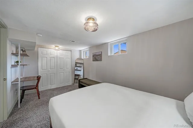 a bedroom with a bed and a large window