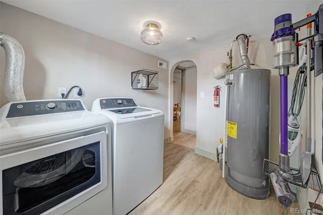 a front view of a house with a yard and large trees