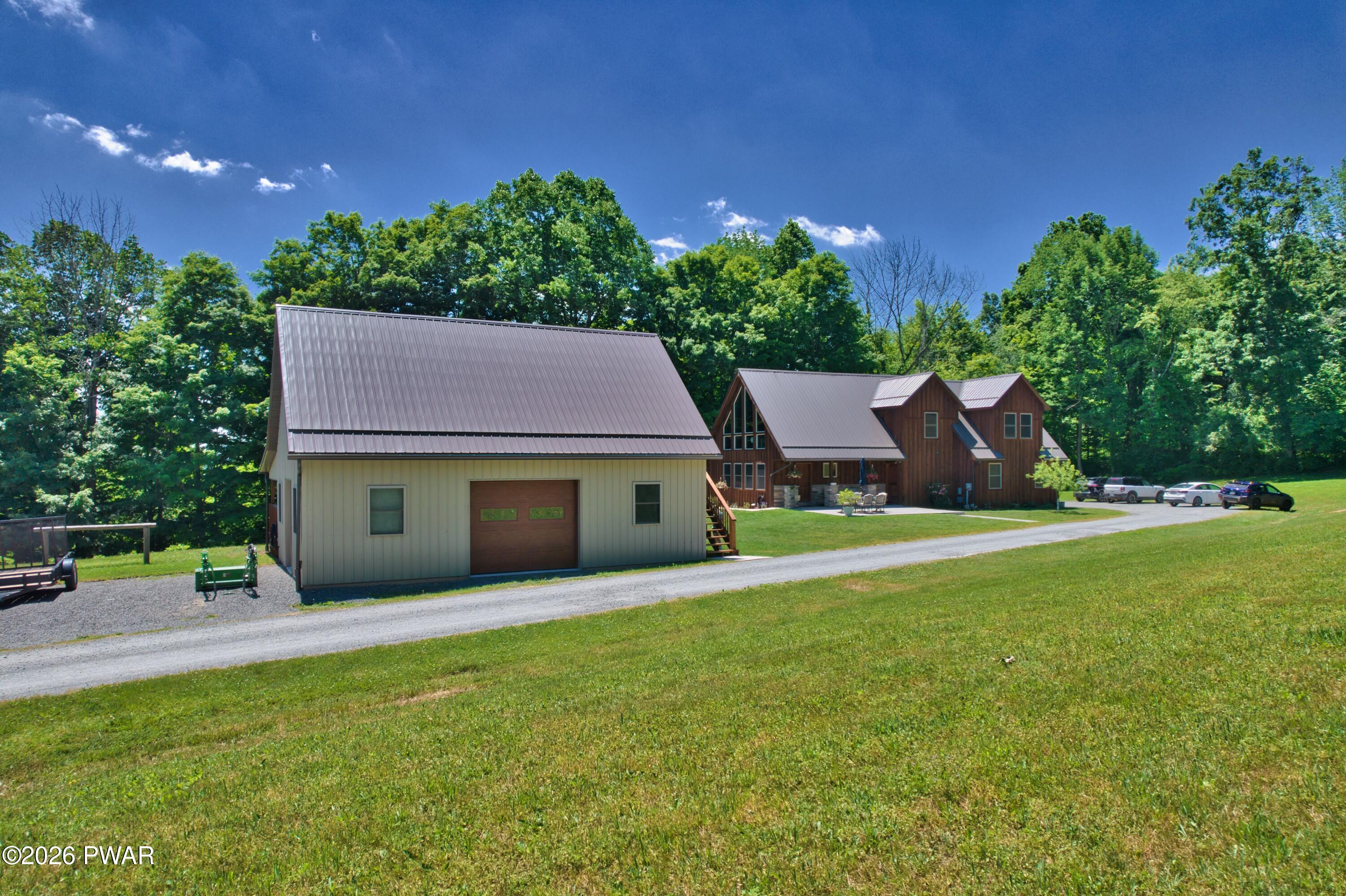 149 Sheards Road Milanville, PA 18443 - Photo 18 of 57 a view of a house with pool and a yard