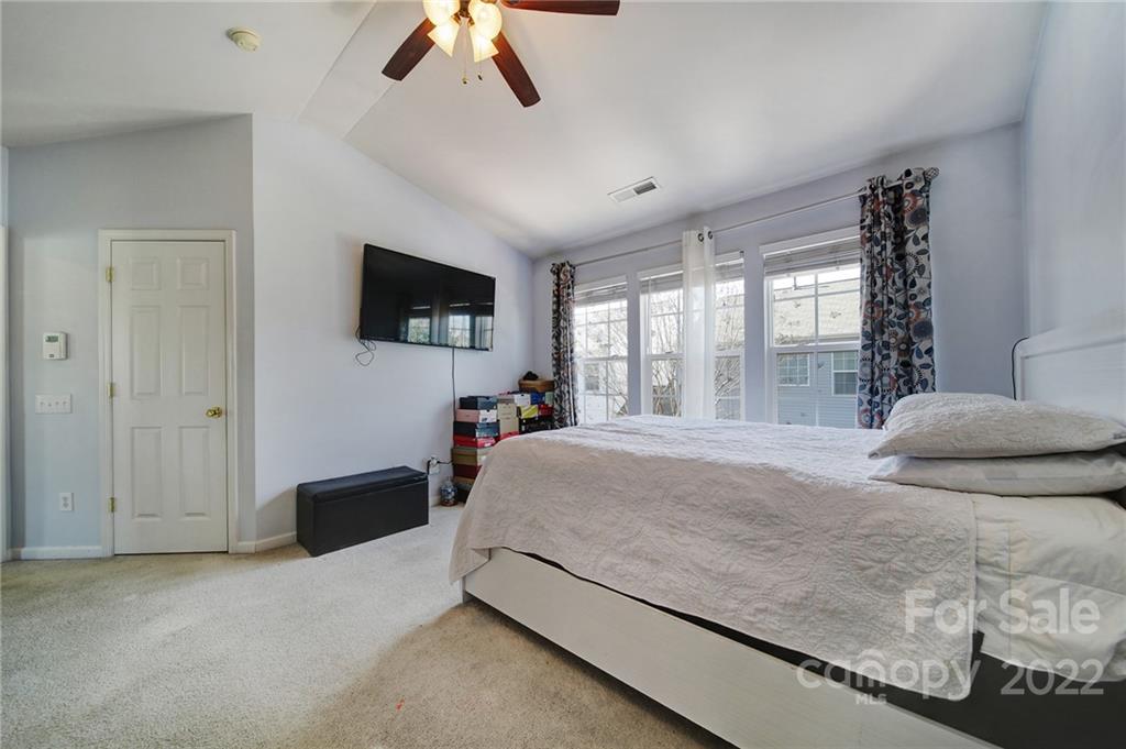11428 Grove Point Road Charlotte, NC 28277 - Photo 18 of 36 a bedroom with a bed and a flat tv screen on dresser