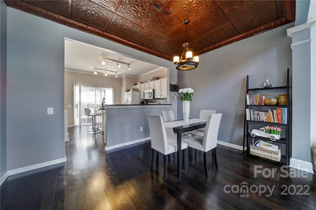 11428 Grove Point Road Charlotte, NC 28277 - Photo 5 of 36 a dining room with furniture and wooden floor