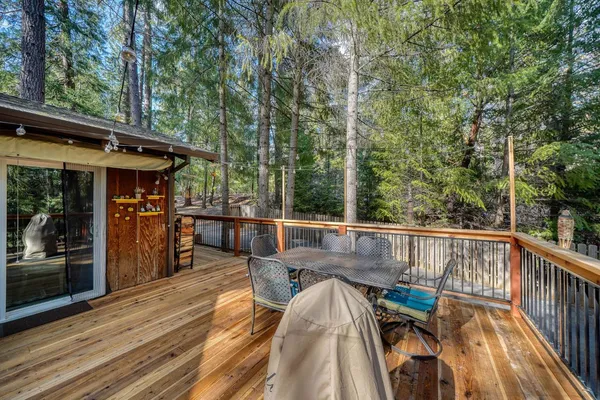 a living room with stainless steel appliances kitchen island granite countertop furniture and a rug