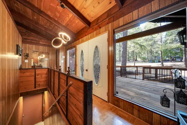 a kitchen with a sink appliances cabinets and a large window