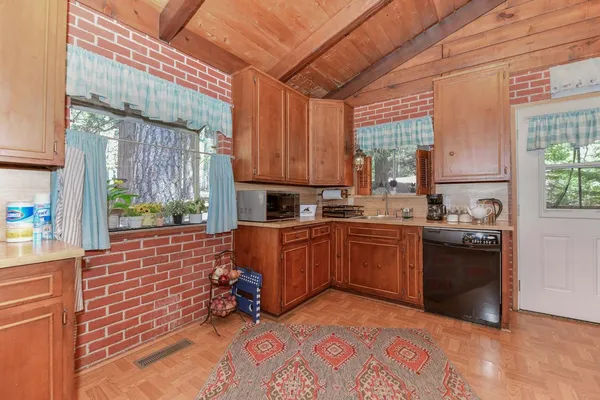 a kitchen with refrigerator and cabinets