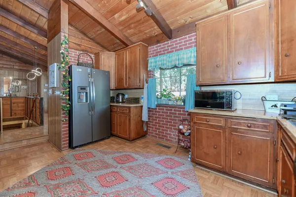 a kitchen with stainless steel appliances granite countertop a sink and a wooden cabinets
