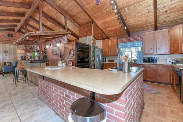 a dining room with furniture and a floor to ceiling window