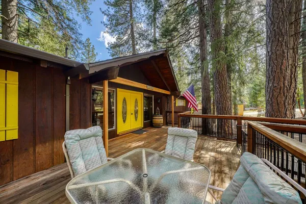 a view of backyard with outdoor seating and wooden fence