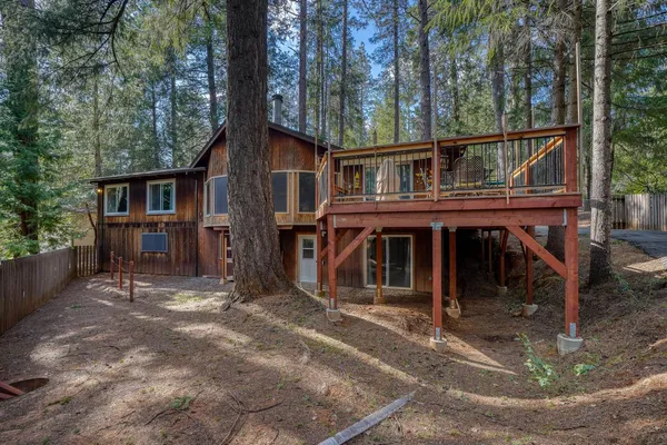 a view of a patio with couches chairs and wooden floor