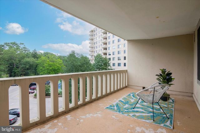 a balcony with chairs and a table