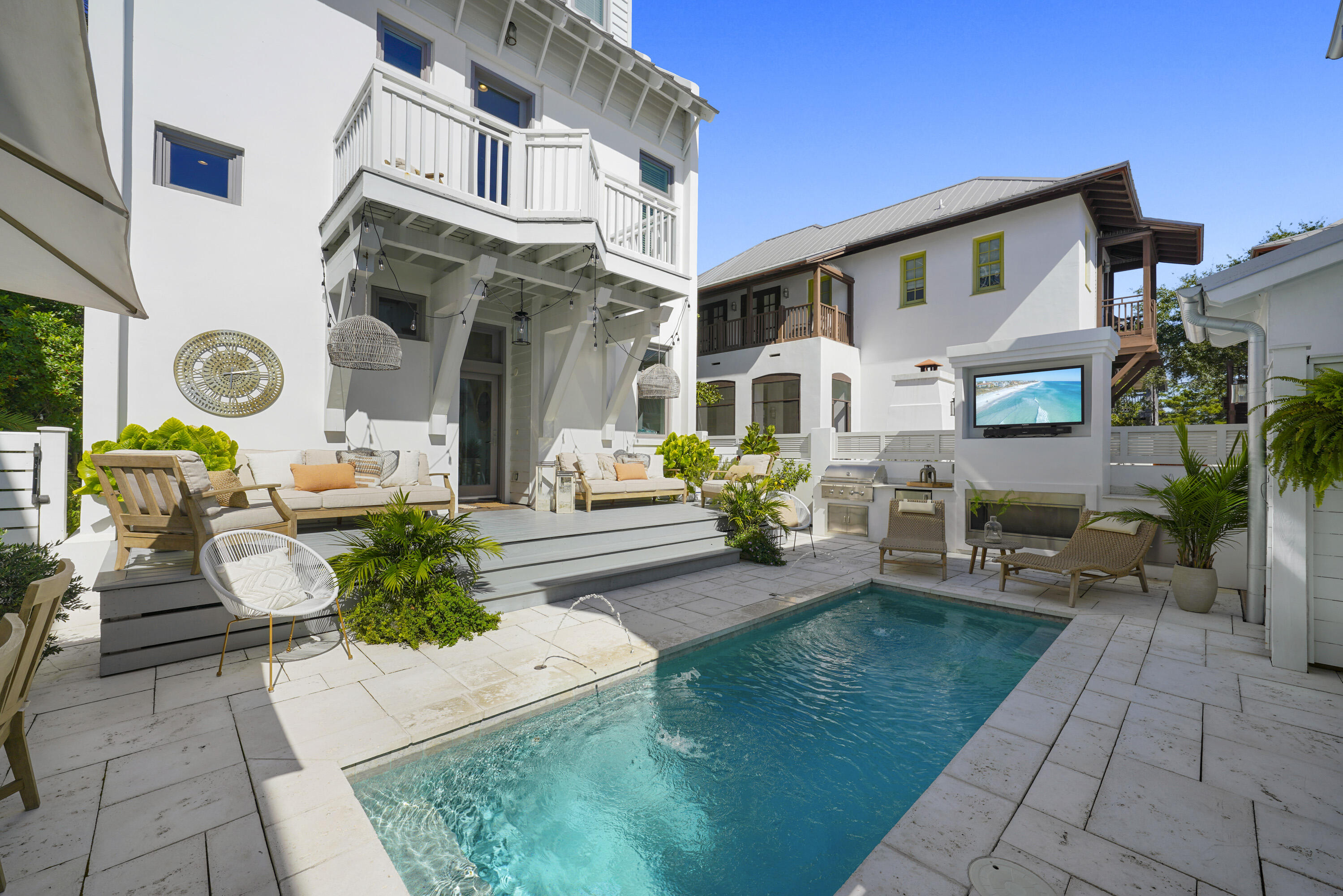 a front view of a house with garden and seating area