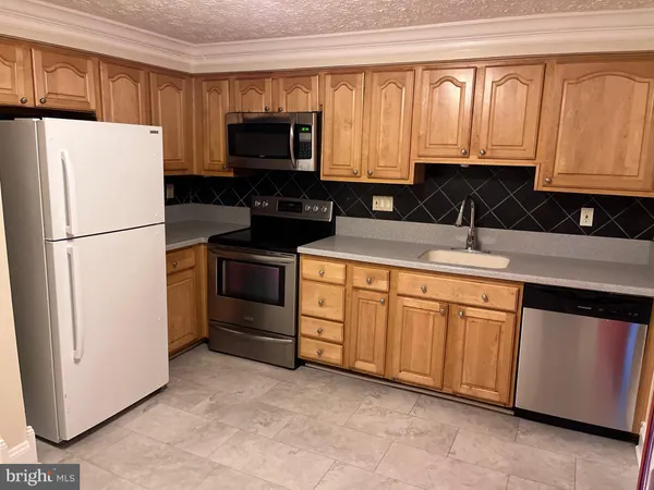 a kitchen with a refrigerator stove and microwave