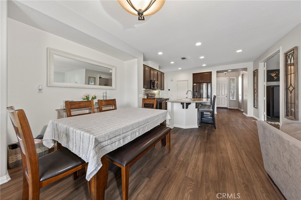 1433 Fall Brook Road Beaumont, CA 92223 - Photo 11 of 33 a living room with stainless steel appliances furniture wooden floor and a kitchen view