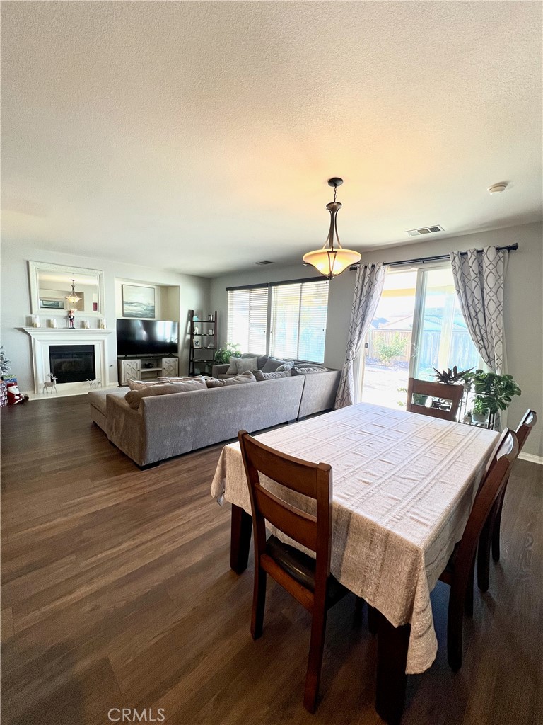 1433 Fall Brook Road Beaumont, CA 92223 - Photo 12 of 33 a view of a dining room with furniture and a wooden floor